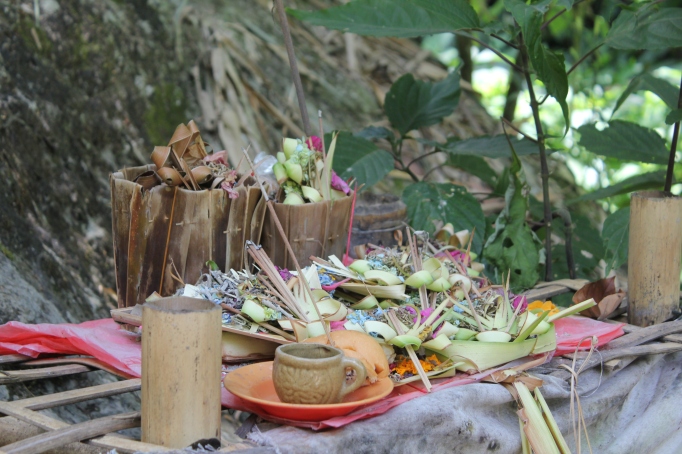 Balinese offerings near a waterfall in Munduk
